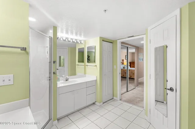 a bathroom with a mirror sink and glass door