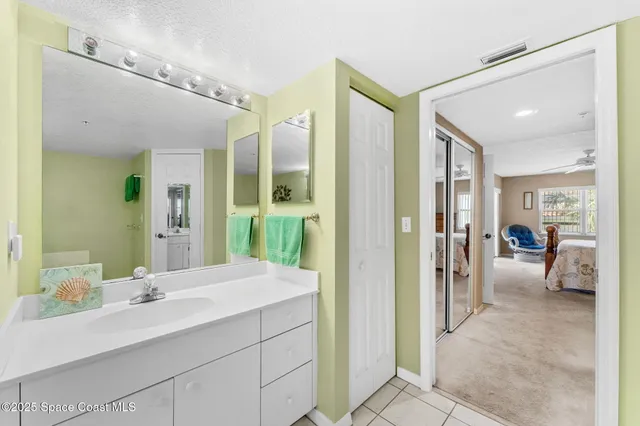 a en suite bathroom with a sink mirror and shower