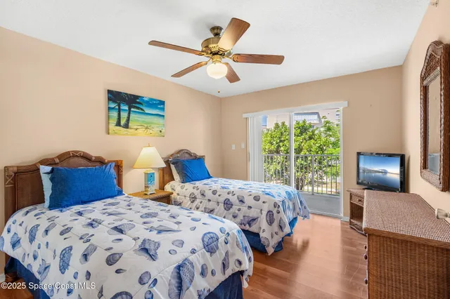 a bedroom with two beds and a chandelier