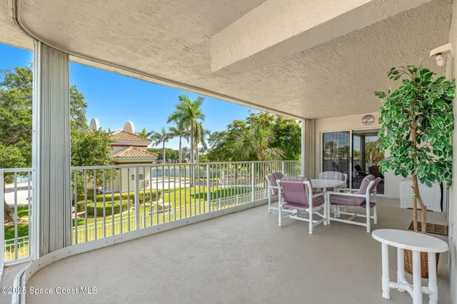 a balcony with furniture and garden view