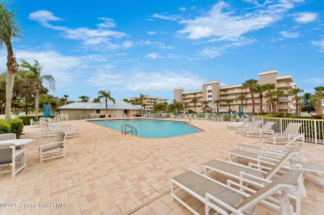 a view of a swimming pool with an outdoor seating