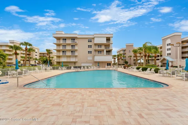 a view of a swimming pool with a lawn chairs