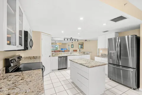 a kitchen with a refrigerator sink and stove