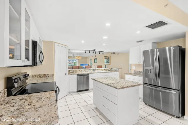 a kitchen with a refrigerator sink and stove