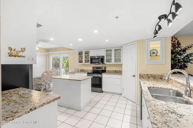 a kitchen with a sink stove and refrigerator