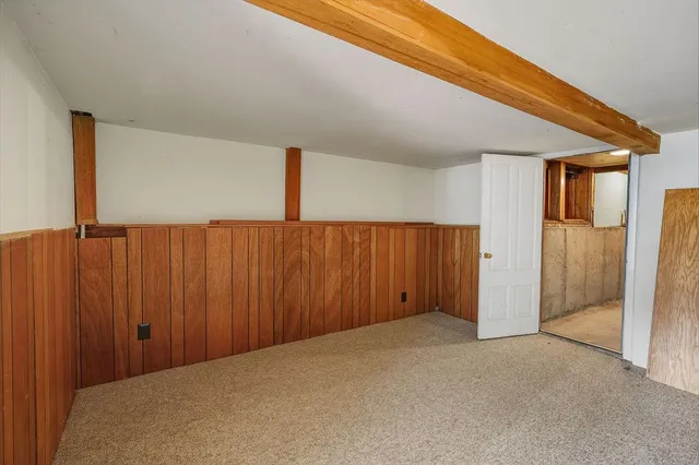 an empty room with a wooden walls