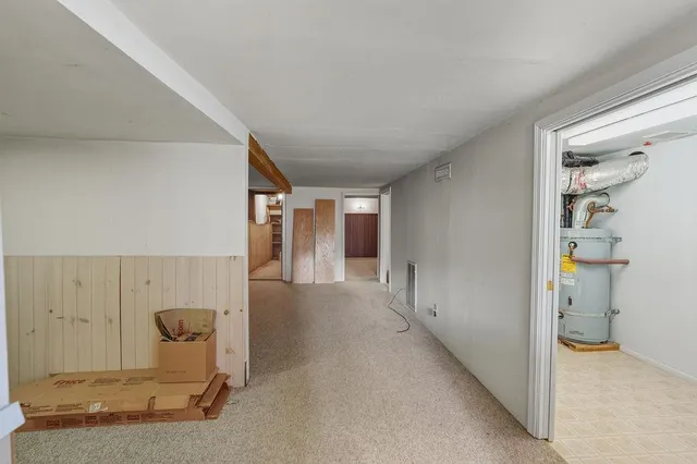 a hallway with a chandelier and wooden floor