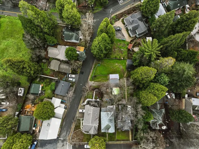 an aerial view of houses with yard