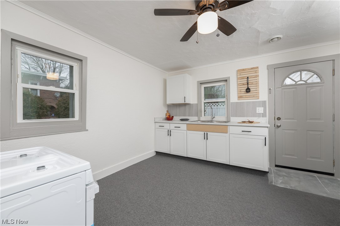 6273-6275 Manchester Road Clinton, OH 44216 - Photo 15 of 27 Kitchen with white cabinets, a wealth of natural light, ceiling fan, and white range oven