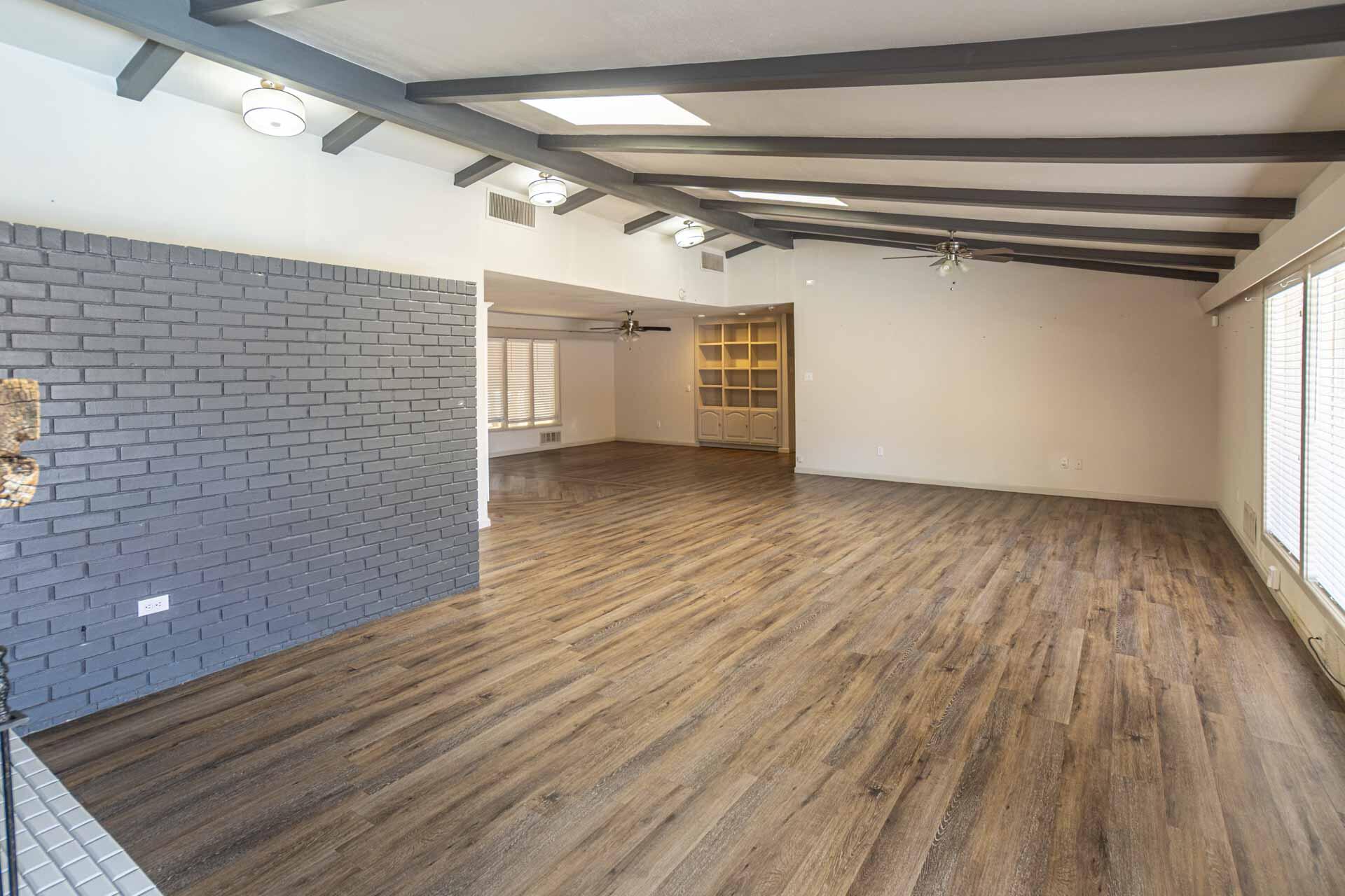 2136 57th Street Lubbock, TX 79412 - Photo 6 of 41 a view of an empty room with wooden floor and a window