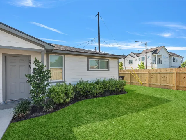 a front view of a house with a garden and yard