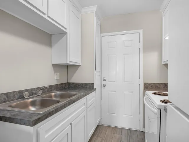 a kitchen with a sink and cabinets