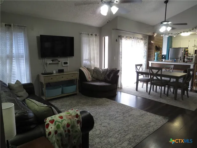 a living room with furniture and a chandelier
