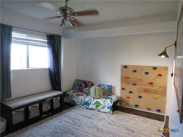 a bathroom with a toilet and a shower curtain