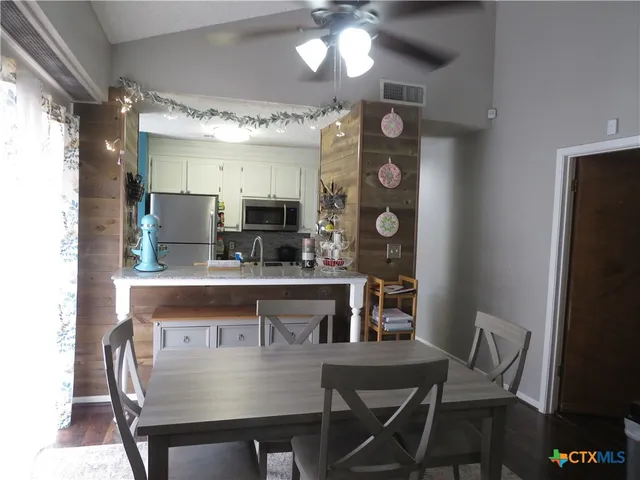 a view of a dining room with furniture and chandelier