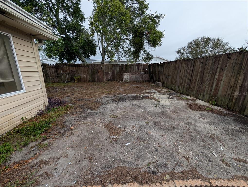 3227 Darlington Road Holiday, FL 34691 - Photo 14 of 15 a view of a backyard with wooden fence