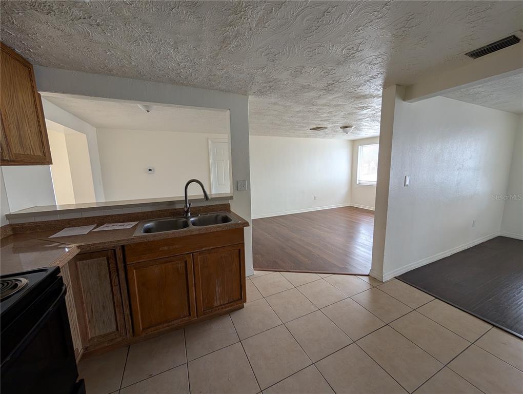 3227 Darlington Road Holiday, FL 34691 - Photo 3 of 15 a kitchen with a sink and cabinets