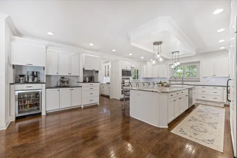 a kitchen with a white cabinets and white appliances