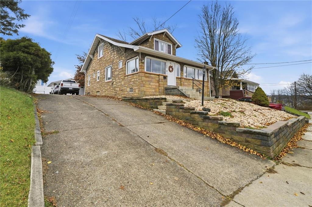 244 Tyler Avenue Washington, PA 15301 - Photo 23 of 27 a view of a white house next to a road with big yard
