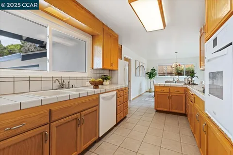 a large kitchen with a sink and cabinets