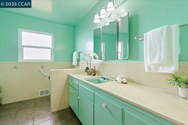 a bathroom with a sink a mirror and a window