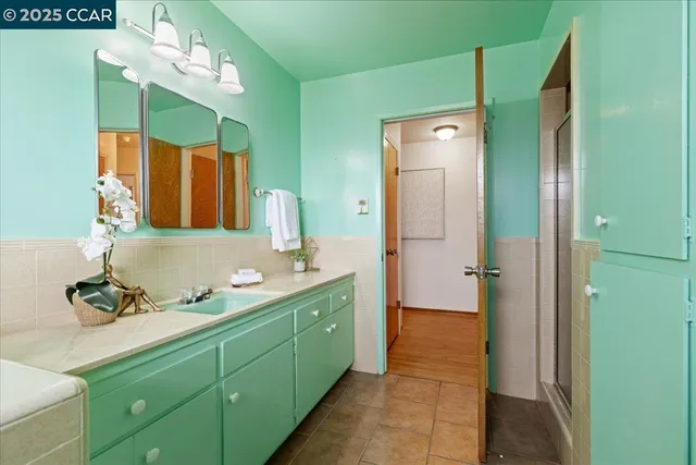 a bathroom with a double vanity sink and a mirror