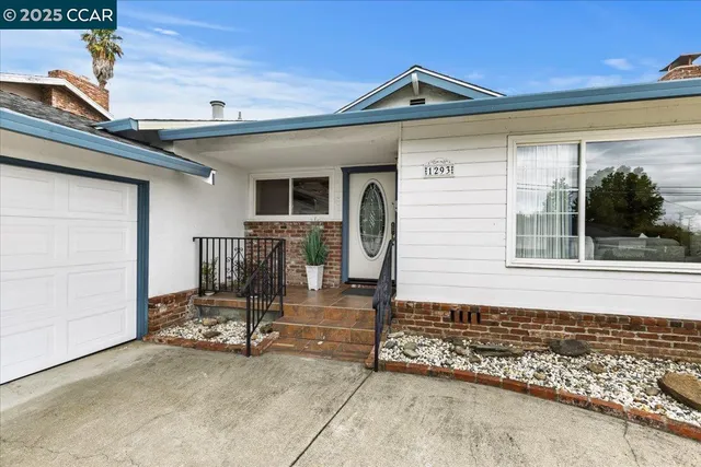a front view of a house with sitting area