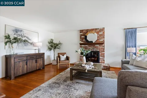 a living room with furniture a fireplace and a table