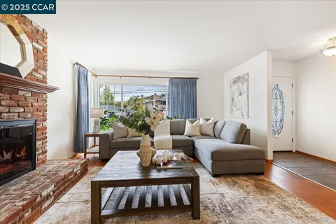 a living room with furniture a fireplace and a table