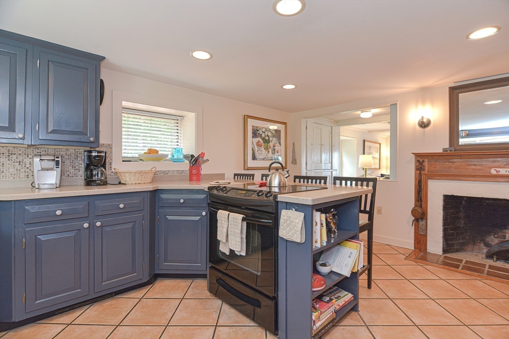 93 Granite Street, Unit 1 Rockport, MA 01966 - Photo 12 of 24 a kitchen with stainless steel appliances granite countertop a stove a sink dishwasher and a refrigerator
