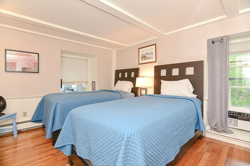 93 Granite Street, Unit 1 Rockport, MA 01966 - Photo 14 of 24 a bedroom with a bed and a large window