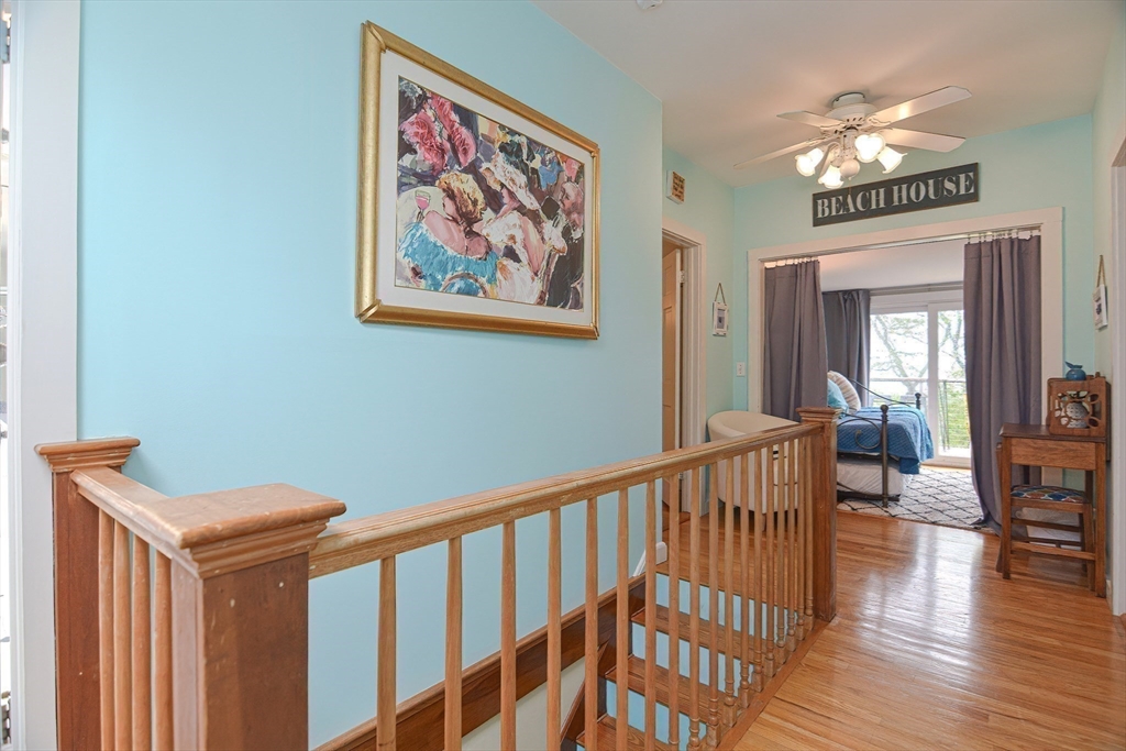 93 Granite Street, Unit 1 Rockport, MA 01966 - Photo 17 of 24 a view of a hallway with wooden floor and windows