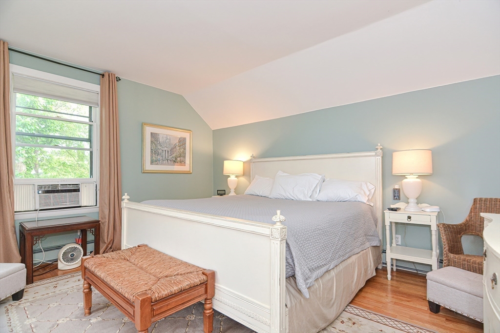 93 Granite Street, Unit 1 Rockport, MA 01966 - Photo 18 of 24 a bedroom with a bed and a table in it