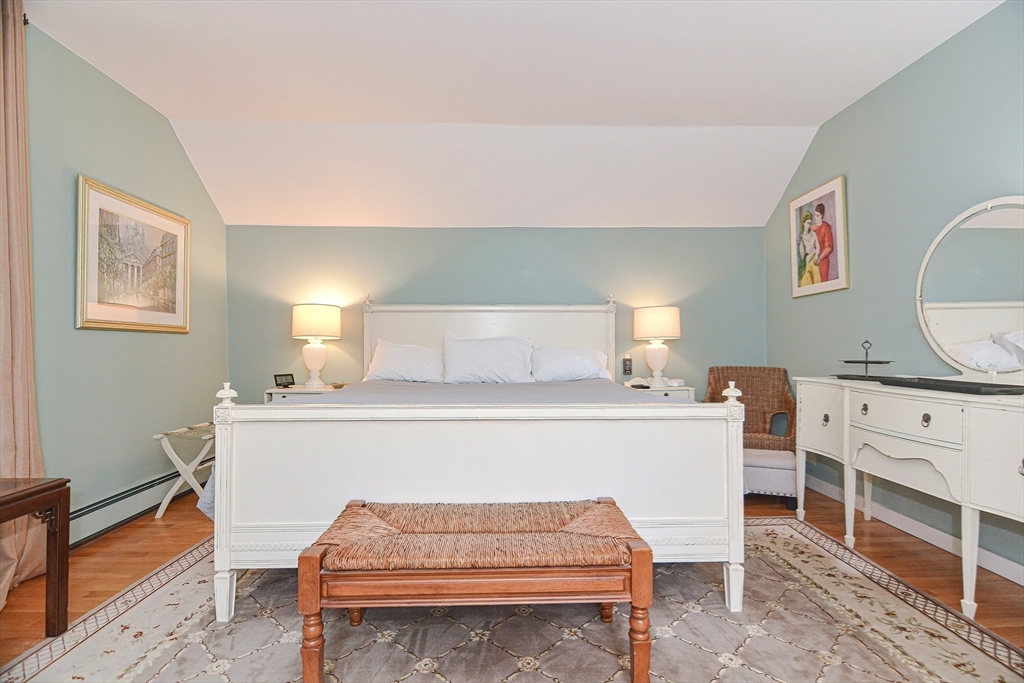 93 Granite Street, Unit 1 Rockport, MA 01966 - Photo 19 of 24 a bedroom with a bed and a dresser in it