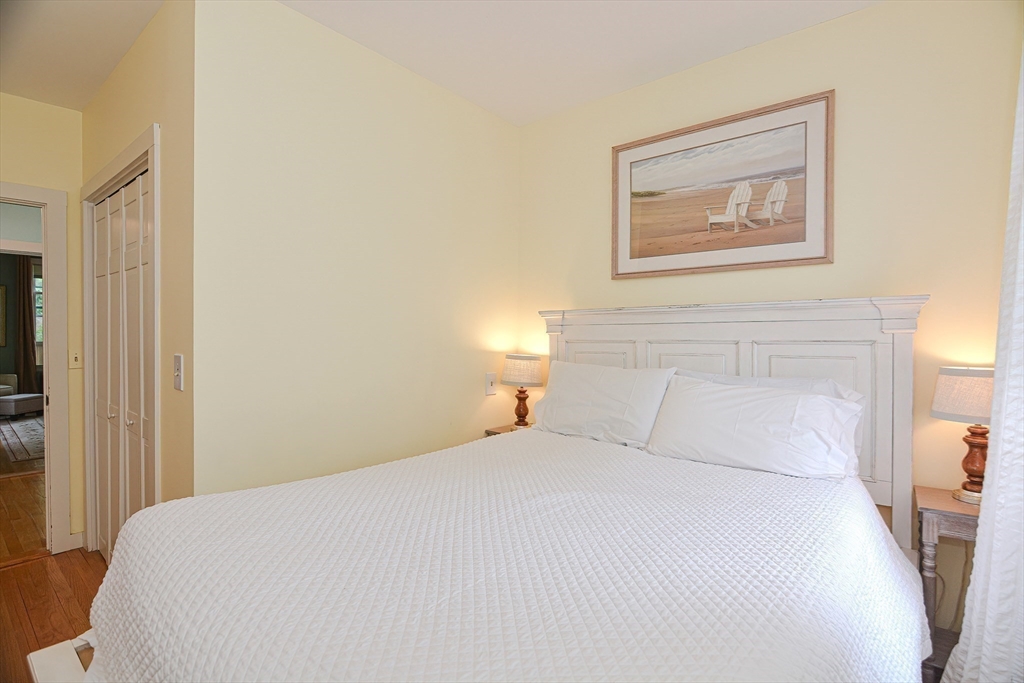 93 Granite Street, Unit 1 Rockport, MA 01966 - Photo 20 of 24 a bedroom with a bed and a painting on the wall