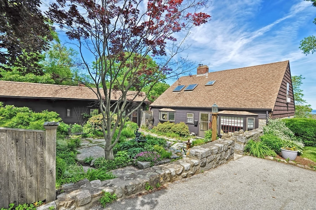 93 Granite Street, Unit 1 Rockport, MA 01966 - Photo 3 of 24 a house that has a tree in front of it