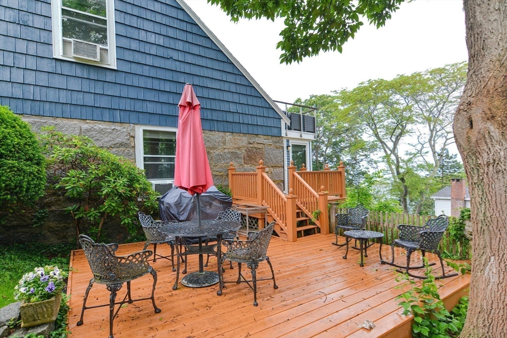93 Granite Street, Unit 1 Rockport, MA 01966 - Photo 5 of 24 a view of a table and chairs in patio of the house