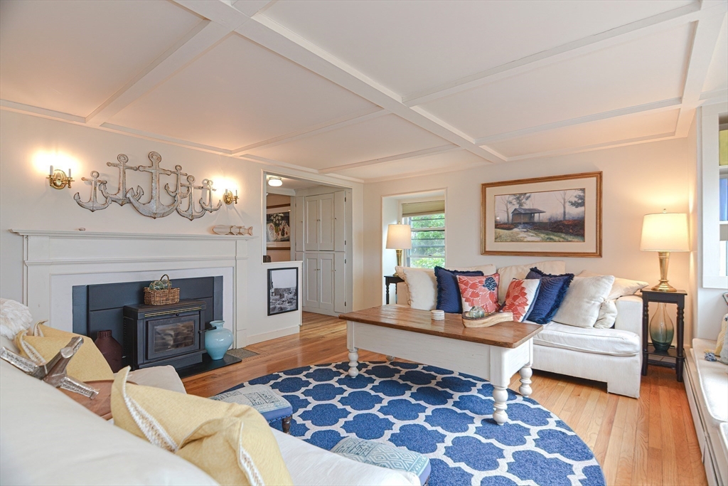 93 Granite Street, Unit 1 Rockport, MA 01966 - Photo 6 of 24 a living room with furniture and a fireplace