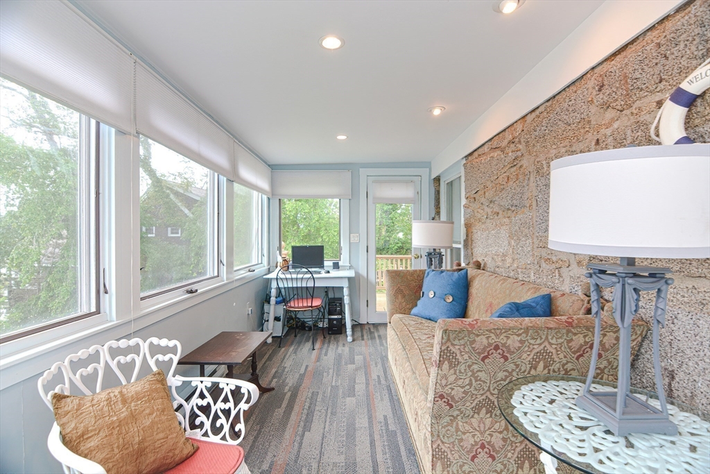 93 Granite Street, Unit 1 Rockport, MA 01966 - Photo 9 of 24 a living room with furniture and a large window