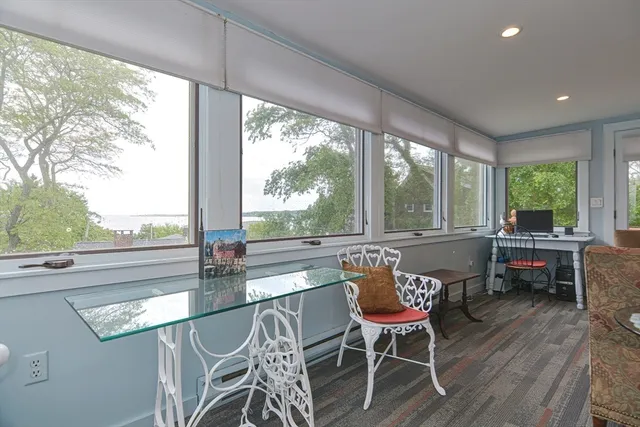 a kitchen with stainless steel appliances granite countertop a sink a stove a dining table and chairs