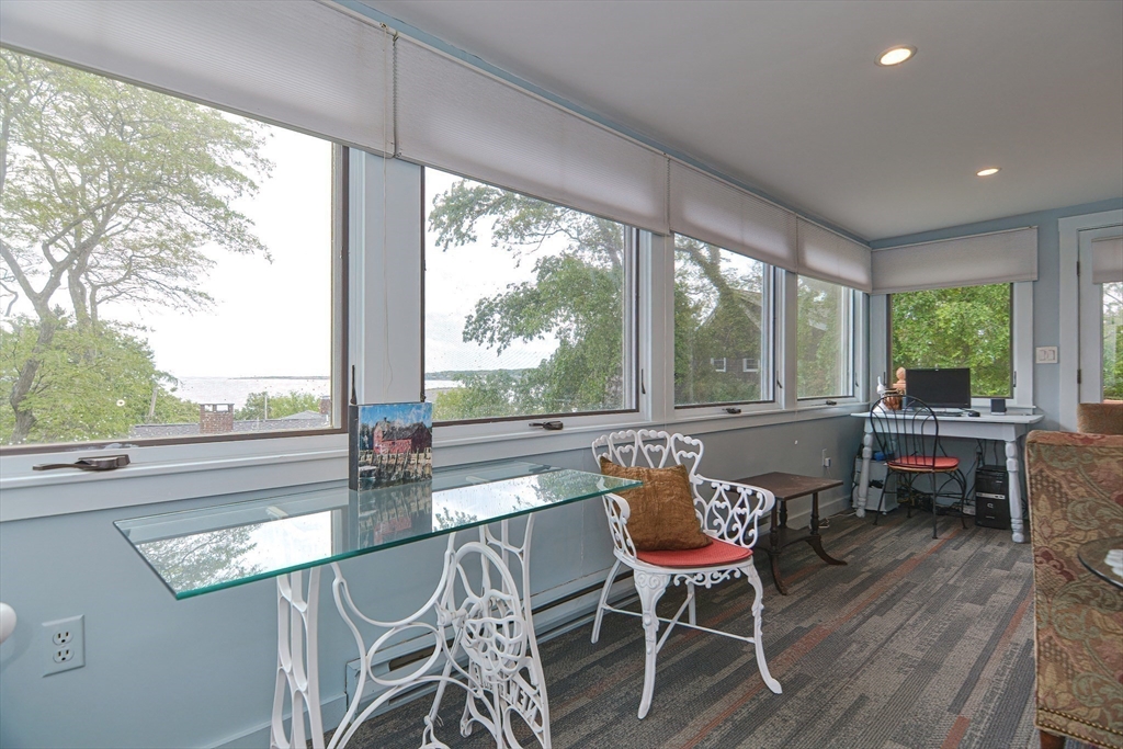 93 Granite Street, Unit 1 Rockport, MA 01966 - Photo 10 of 24 a living room with furniture and a large window