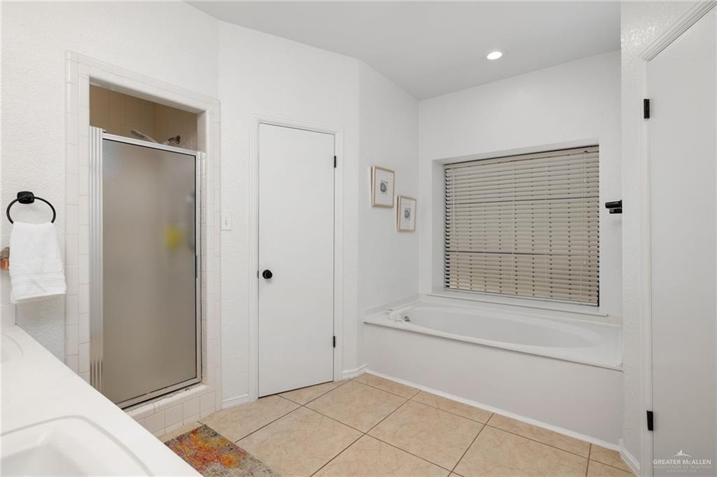3309 South McColl Road Edinburg, TX 78539 - Photo 13 of 27 Bathroom featuring light tile patterned floors, a shower stall, a bath, recessed lighting, and double vanity