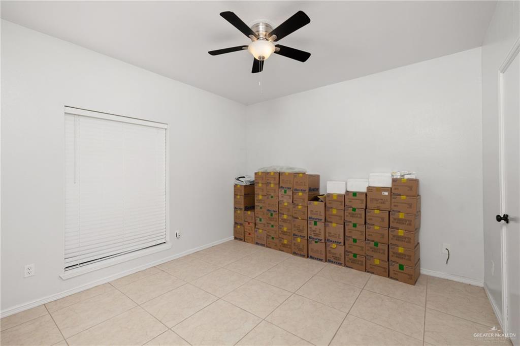 3309 South McColl Road Edinburg, TX 78539 - Photo 16 of 27 Empty room featuring light tile patterned floors and a ceiling fan