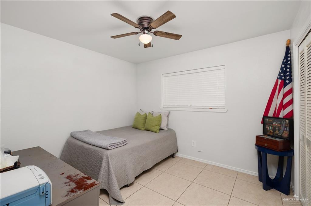 3309 South McColl Road Edinburg, TX 78539 - Photo 17 of 27 Bedroom with ceiling fan and light tile patterned floors