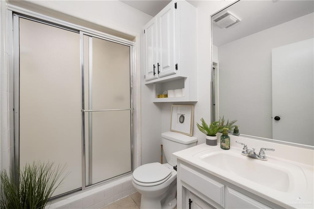 3309 South McColl Road Edinburg, TX 78539 - Photo 18 of 27 Bathroom with a stall shower, vanity, and light tile patterned flooring
