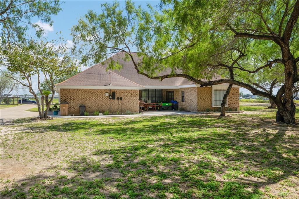 3309 South McColl Road Edinburg, TX 78539 - Photo 19 of 27 View of front of property with brick siding, a front lawn, and a patio