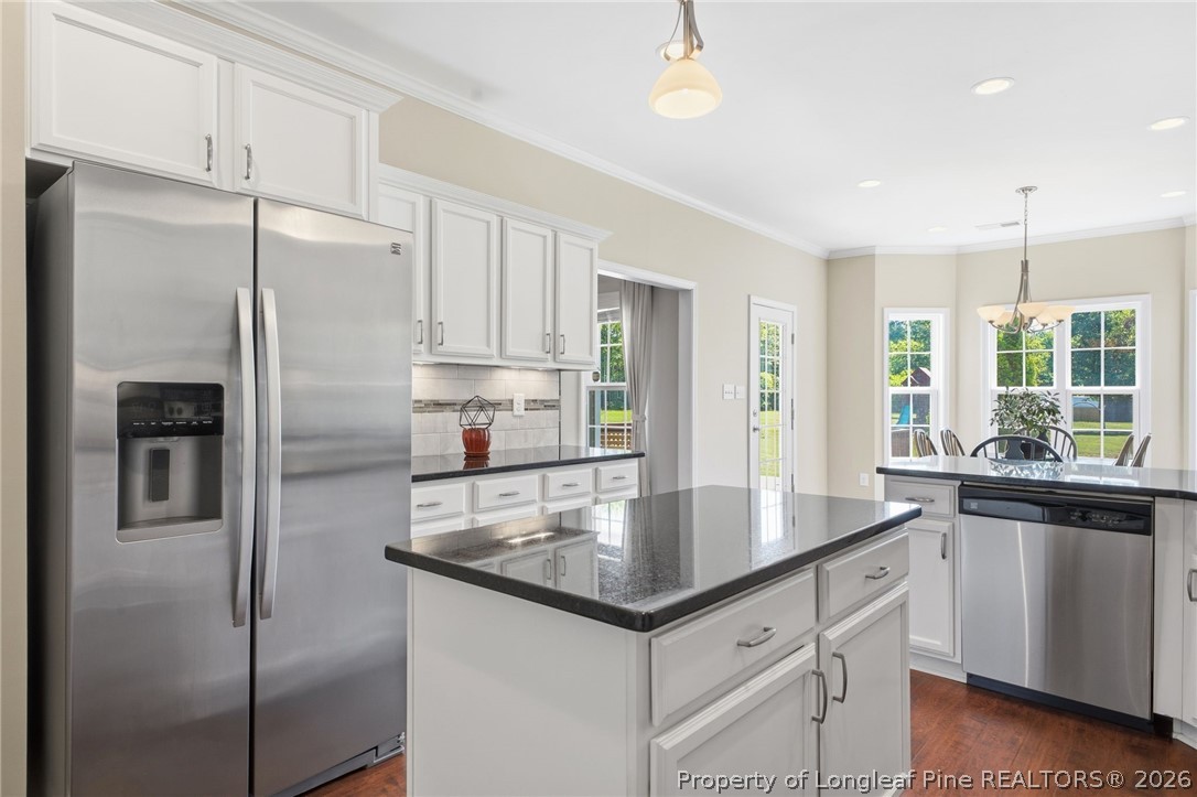 2589 June Johnson Road Raeford, NC 28376 - Photo 11 of 49 a kitchen with stainless steel appliances granite countertop a refrigerator a sink a stove and white cabinets