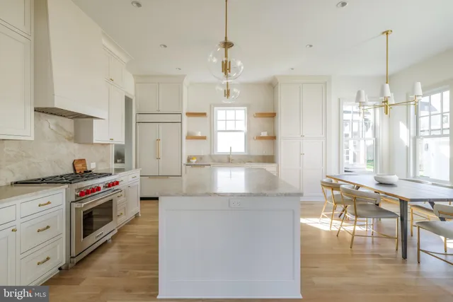 a kitchen with stainless steel appliances granite countertop a stove and a refrigerator
