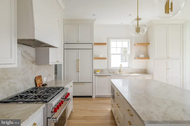a kitchen with granite countertop a sink stove and refrigerator