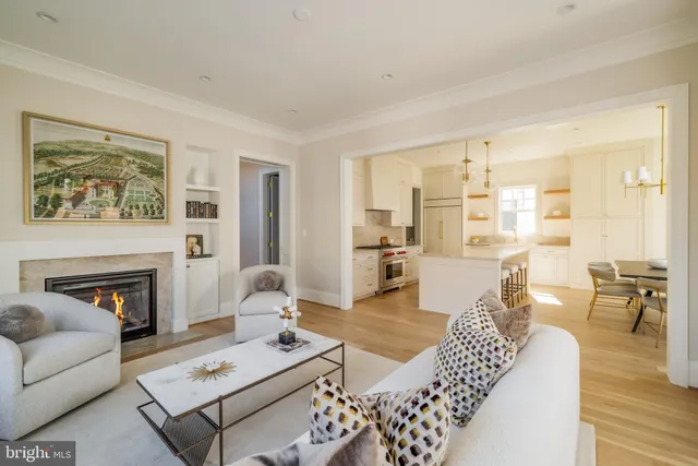 a living room with furniture a fireplace and a table